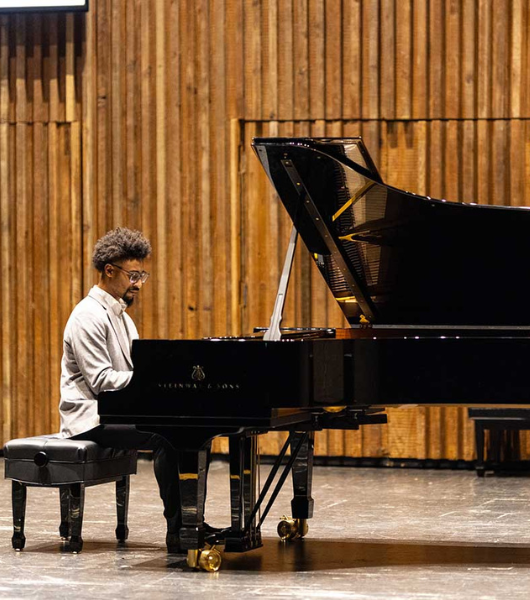 Theron Brown plays a black Steinway Grand Piano